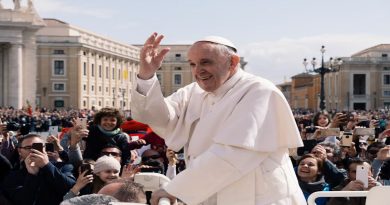 Pope Francis warmly greets a sea of faithful during a public appearance, reflecting his deep connection with the people.
