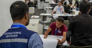 An ANFREL observer monitors Filipino staff conducting a random manual ballot audit during Eleksyon 2025.